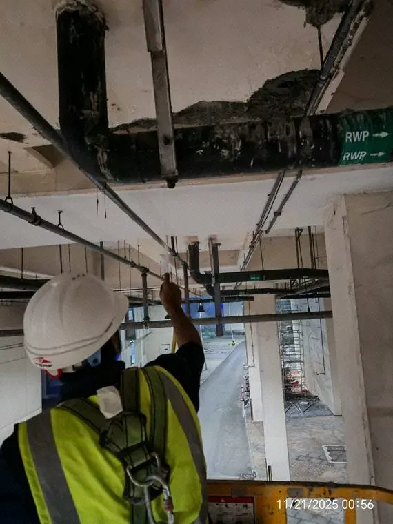 Spalled concrete removed to expose affected reinforcement