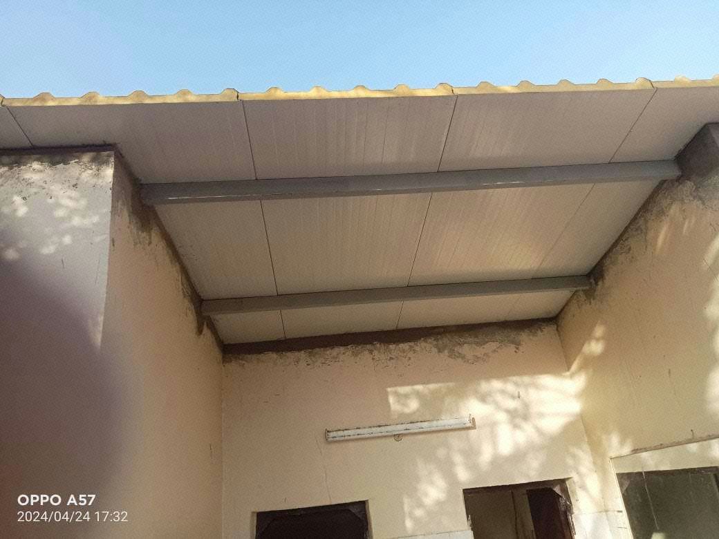 Installation of new sandwich panel roofing in progress