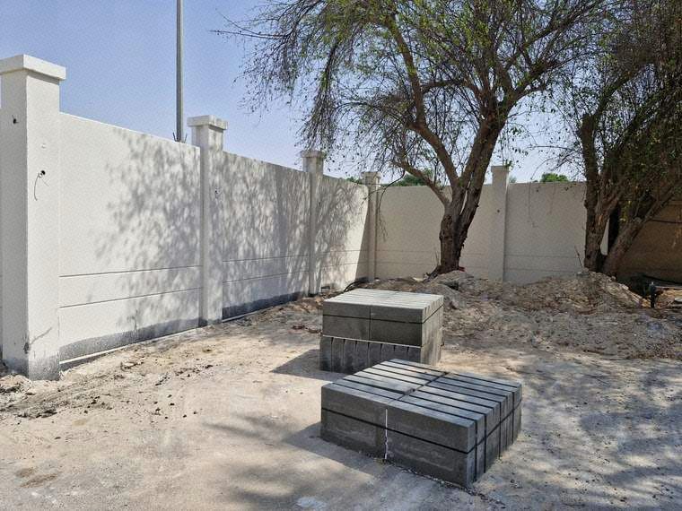 Application of second coat exterior paint finish on boundary wall