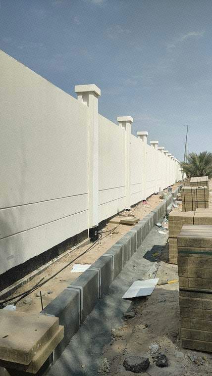 Application of second coat exterior paint finish on boundary wall
