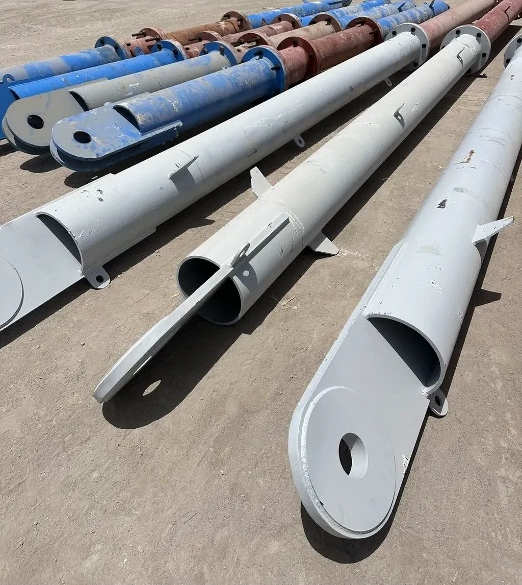 Large steel pipe sections staged in the yard